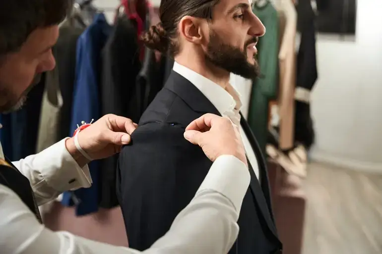 experienced clothier altering suit of male